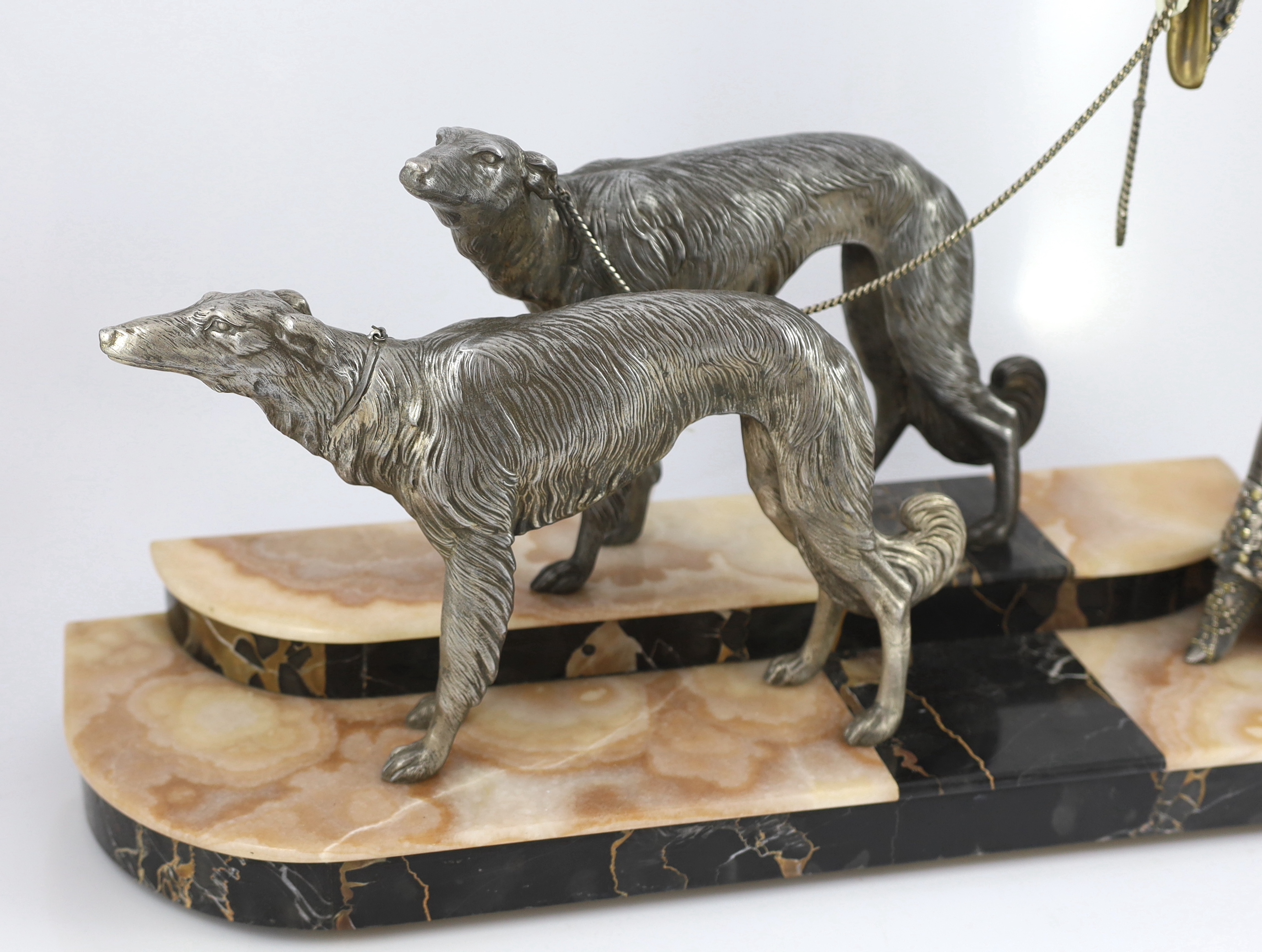 Georges Gori (French, 1894-1944). An Art Deco silvered bronze, spelter and composition group of an elegant lady and two borzoi, 80cm wide, 20cm deep, 51cm high